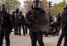 Can 70,000 Police Keep France’s Protests Under Control? French riot police in helmets and shields standing in a line on a Paris street during a protest.
