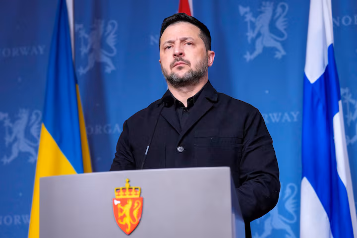 Ukrainian President Volodymyr Zelenskiy, speaking at a podium during a press conference in Oslo, Norway.
