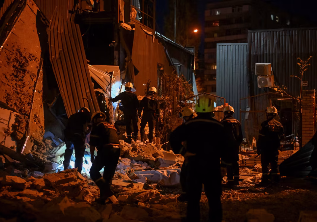 Emergency responders at the site of a damaged building in Zaporizhzhia following a Russian overnight strike.