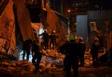 Six Injured In Fresh Russian Strikes Emergency responders at the site of a damaged building in Zaporizhzhia following a Russian overnight strike.